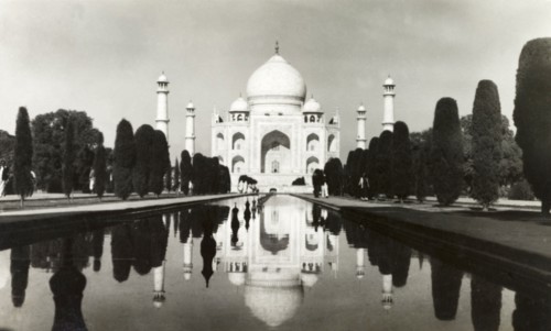 The Taj Mahal, circa 1925. View of the Taj Mahal, reflected in the central canal running up to its