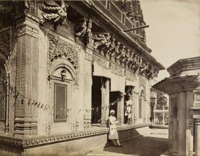 Raja Amethi's temple. View of an exterior carved stone wall, decorated with strings of bunting, at