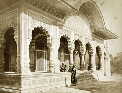 Bhaldwun Singh's Palace. Two figures engage in conversation outside the decorative walls of
