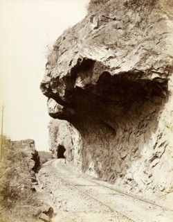 Colombo to Kandy railway. A section of mountainside has been cut away to make access for the