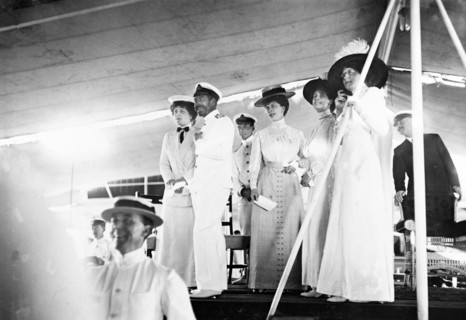 On board entertainment. King George V (r.1910-36), Queen Mary and her Ladies in Waiting are