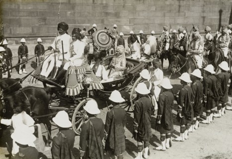 Procession of state entry. The Maharajah of Idar rides inside a horse-drawn carriage in the