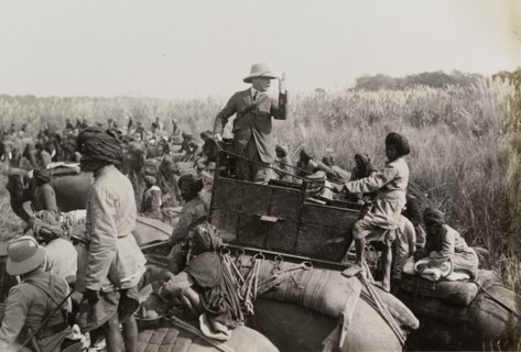 The Duke of Teck gesticulates. The Duke of Teck (1868-1927) stands up in his elephant's howdah,