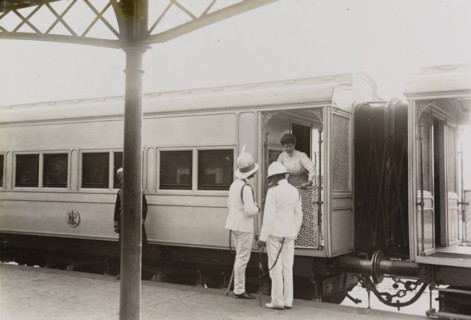 Queen Mary leans from the royal train. Queen Mary leans from the royal train to talk with Sir Derek