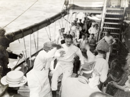 Antics aboard the S.S. Balmoral Castle. Crew members aboard the S.S. Balmoral Castle clown about on