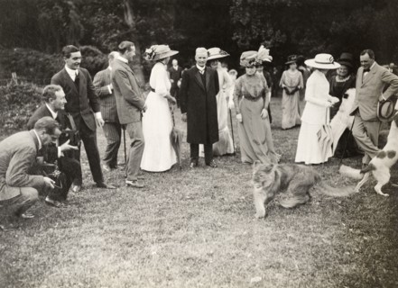 Lion cub at a royal garden party, Bloemfontein. Formally dressed guests are entertained by the