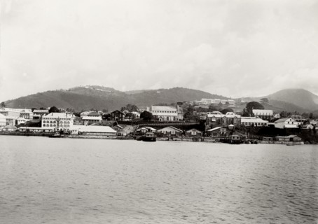 Coastal town in southern Africa. View of an unidentified coastal town surrounded by mountains. The