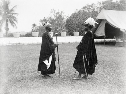 Two Bechuanaland chiefs. Two finely dressed Bechuanaland chiefs stand facing each other at an