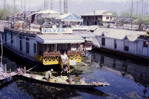 River tradesman on Dhal Lake. A river tradesman travels between houseboats moored on Dhal Lake,
