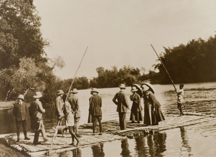 Rafting expedition. A British hunting party are ferried across the Kabani River by raft on an