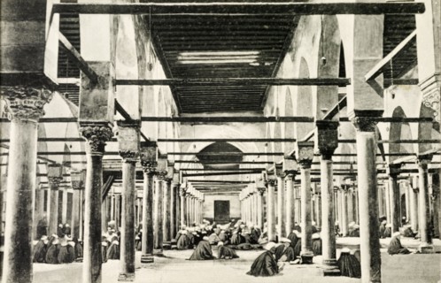 Inside El-Azhar University. Students sit on the floor inside a room lined with pillars at El-Azhar