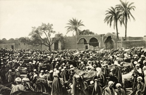 Market at Giza. A throng of people crowd an open air market at Giza. Giza, Egypt, circa 1900. Giza,