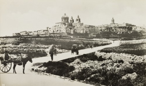 Outskirts of Mdina. People travel along a road on the outskirts of Mdina, the 'citta vechia' or old
