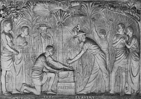 Freedom from Slavery'. A bronze plaque depicts an African slave kneeling to have his chains cut by