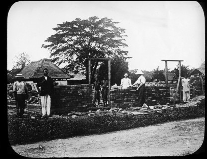 Missionaries build a chapel. European missionary workers help to build a new chapel. The burnt