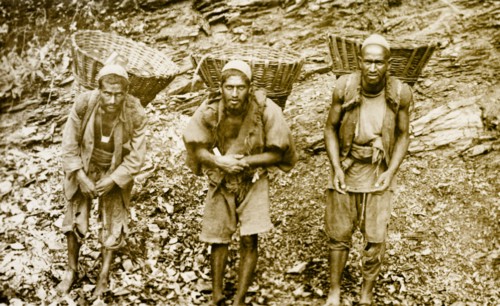 Bheestis' or water carriers. Portrait of three 'bheestis' or water carriers, transporting baskets