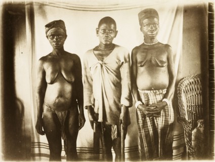 Inhabitants of Bioko. Portrait of a two women and a man from Bioko, posed standing against a