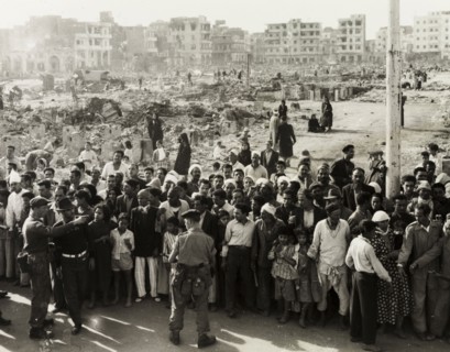 Hungry crowds during the Suez Crisis. British troops control crowds of hungry civilians in the days
