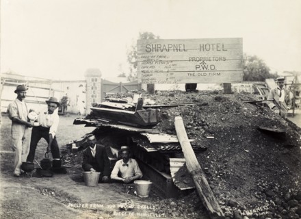 Making tea at the 'Shrapnel Hotel'. British men make tea outside a makeshift bomb shelter, jokingly