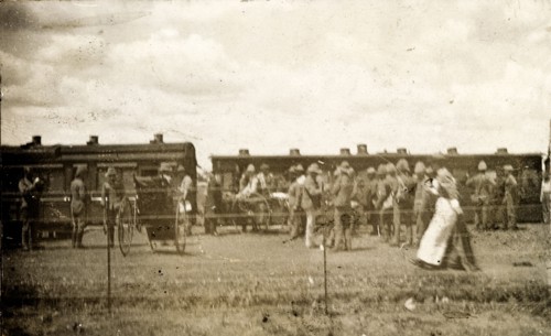 Hospital train at Standerton. A nurse passes a crowd of uniformed troops waiting beside a hospital