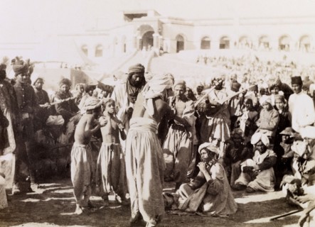 Indian musicians in Sukkur. Indian musicians with stringed instruments play to a gathered crowd,