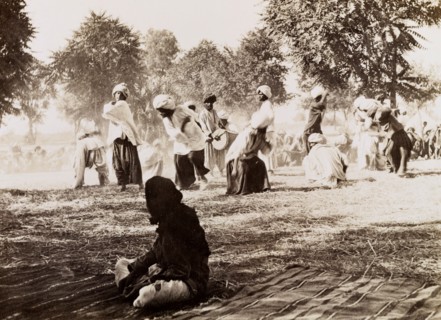 Indian drummers. A drummer is encircled by male dancers in traditional Indian dress during an
