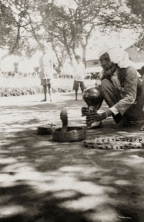 An Indian snake charmer at work. An Indian snake charmer plays a traditional bamboo 'pungi' as he