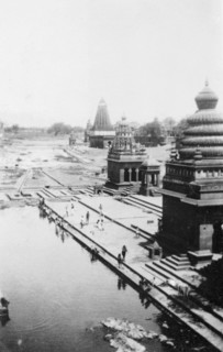 Pilgrims bathing at Wai. Religious pilgrims bathe in the shadows of ornate temples on the River
