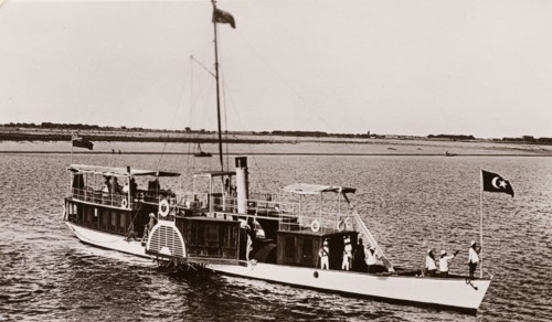 Paddle steamer on the River Nile. A paddle steamer named 'The Elfin' travels along the River Nile,