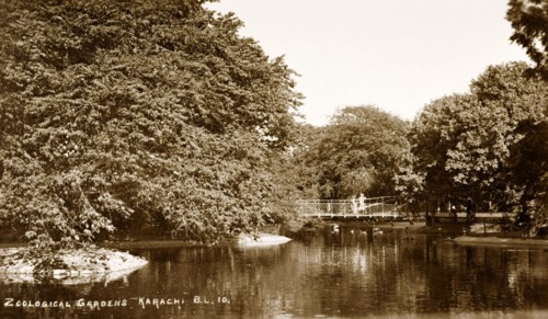 Lake in the Zoological Gardens of Karachi. A footbridge crosses an artificial lake, overhung with