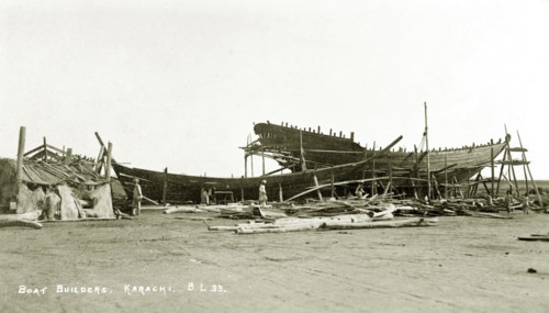 Boat builder's yard in Karachi. Two boats encased in scaffolding undergo construction at a boat