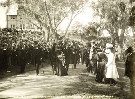 The Duke and Duchess inspect school children, Perth. Crowds of spectators watch as the Duke and