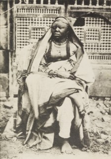 Portrait of an African woman in Egypt. Portrait of an African woman, sitting cross-legged on a