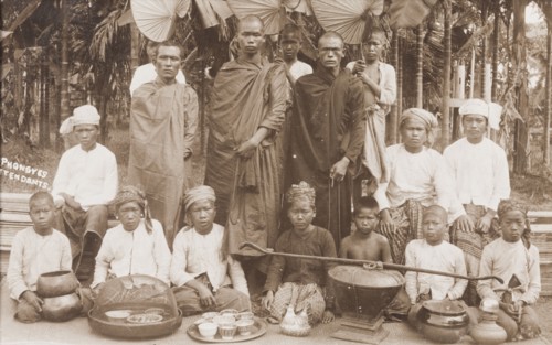 Burmese 'phongyes' with their young attendants. Three robed 'phongyes' (priests) pose for the
