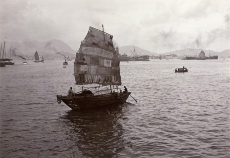 Sampan with a patchwork sail. A Chinese sampan, fitted with a distinctive patchwork sail, sails in