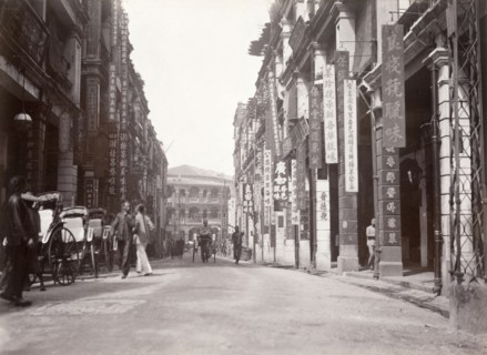 Queen's Road west, Hong Kong. Rickshaw drivers wait for passing business on Queen's Road west. Hong