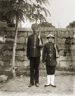 Indian and Chinese officers of the Hong Kong Police Force. Two Hong Kong police officers, one