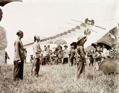 Flying a dragon kite. A long kite, constructed in segments to look like a dragon, is made ready to