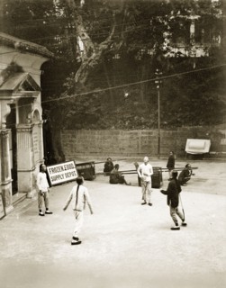Playing football with a shuttlecock. Four young Chinese men play football with a shuttlecock