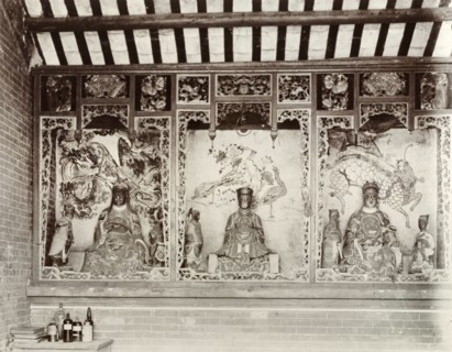 Deities inside a Chinese Joss house. Statues of Chinese deities ('Joss') line the walls inside a