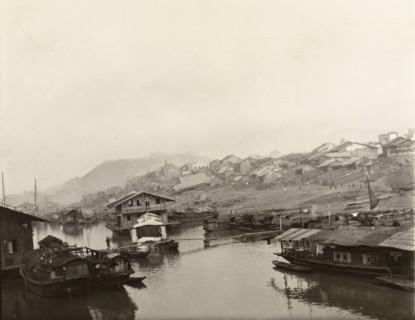 Houseboats at Wuchow. Several houseboats are moored along the banks of the Xijiang River at Wuchow