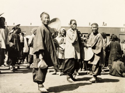 Women at a station on the Peking to Hankow railway line. Three Chinese women gaze curiously into
