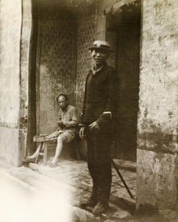 A Chinese policeman. A Chinese policeman, dressed in police uniform and a Western-style hat, smiles