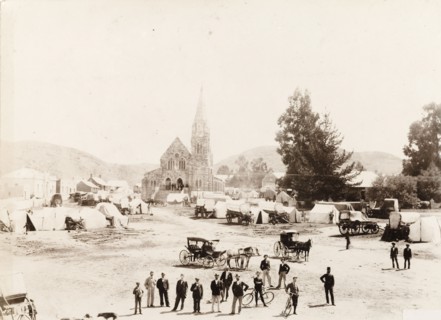Market next to the church in Heidelberg. Tents and covered wagons wait for a market to open outside