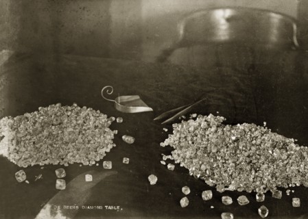 De Beers diamonds. Two piles of diamonds sit on a table at the De Beers offices in Kimberley, with