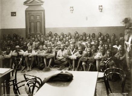 A Matabele indaba with Captain Lawley. Matabele indunas (chiefs) sit on the floor of the Stock