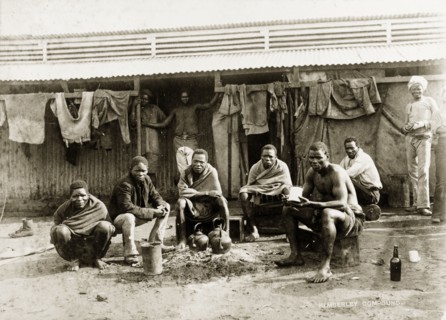 Off-duty diamond mine workers. African workers from the De Beers diamond mine rest outside their