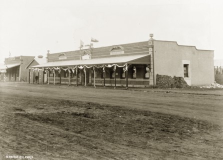 Street decorations on 'White's Building'. A colonial-style commercial building identified as