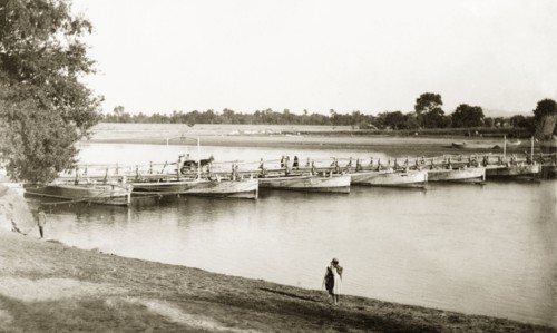 Boats used as pontoons for a bridge, India. A number of boats are used as pontoons to support a