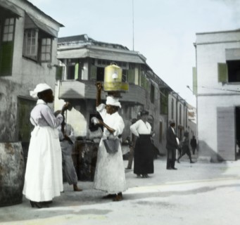 A soft drinks vendor in Barbados. A female street vendor balances a soft drinks decanter on her